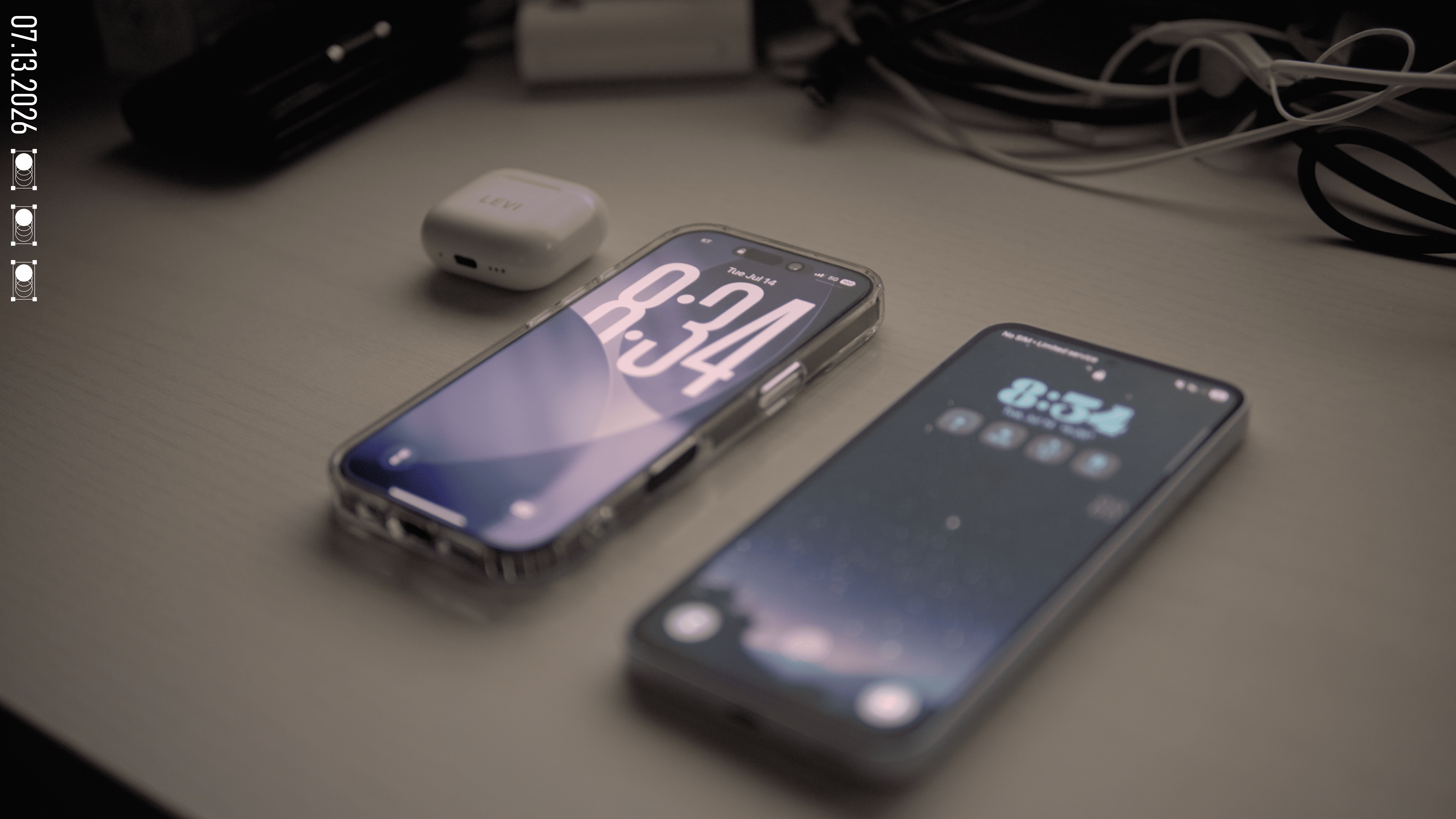 The iPhone 17 and my old Android phone side by side, with the AirPods case behind them