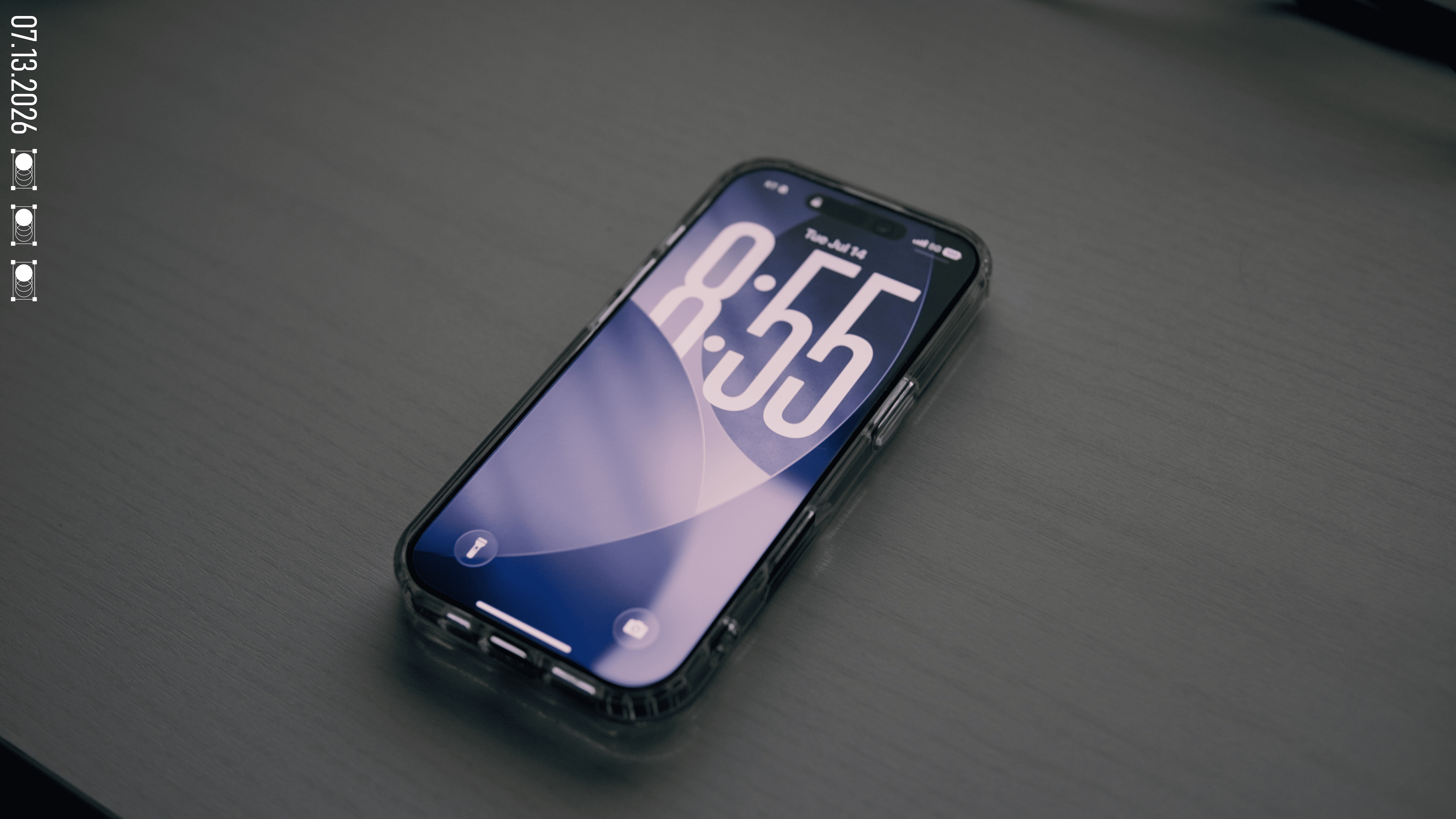 The iPhone 17 alone on the desk, showing its lock screen