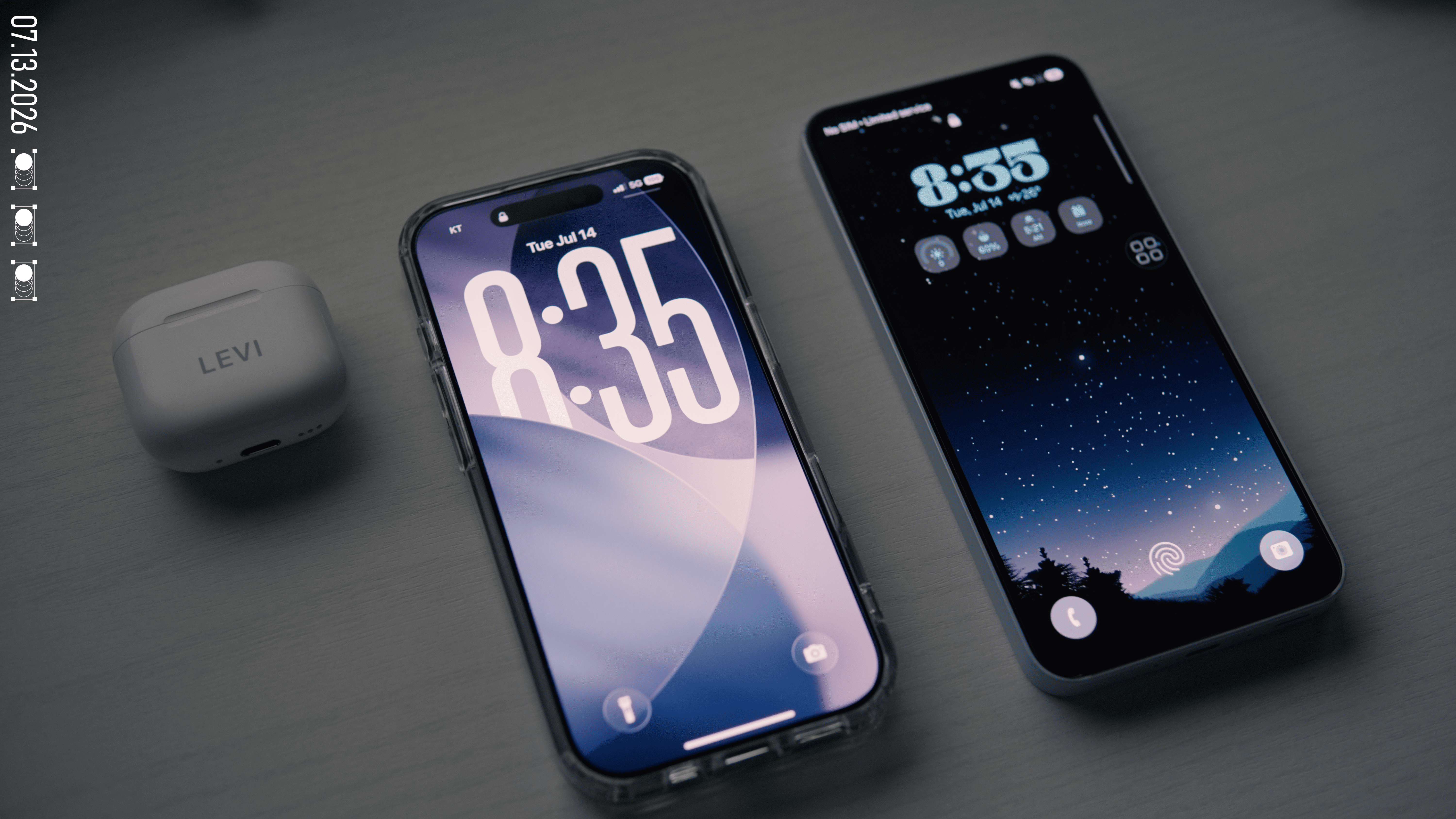 The AirPods case, the iPhone 17 in a clear case, and my old Android phone lined up on a desk