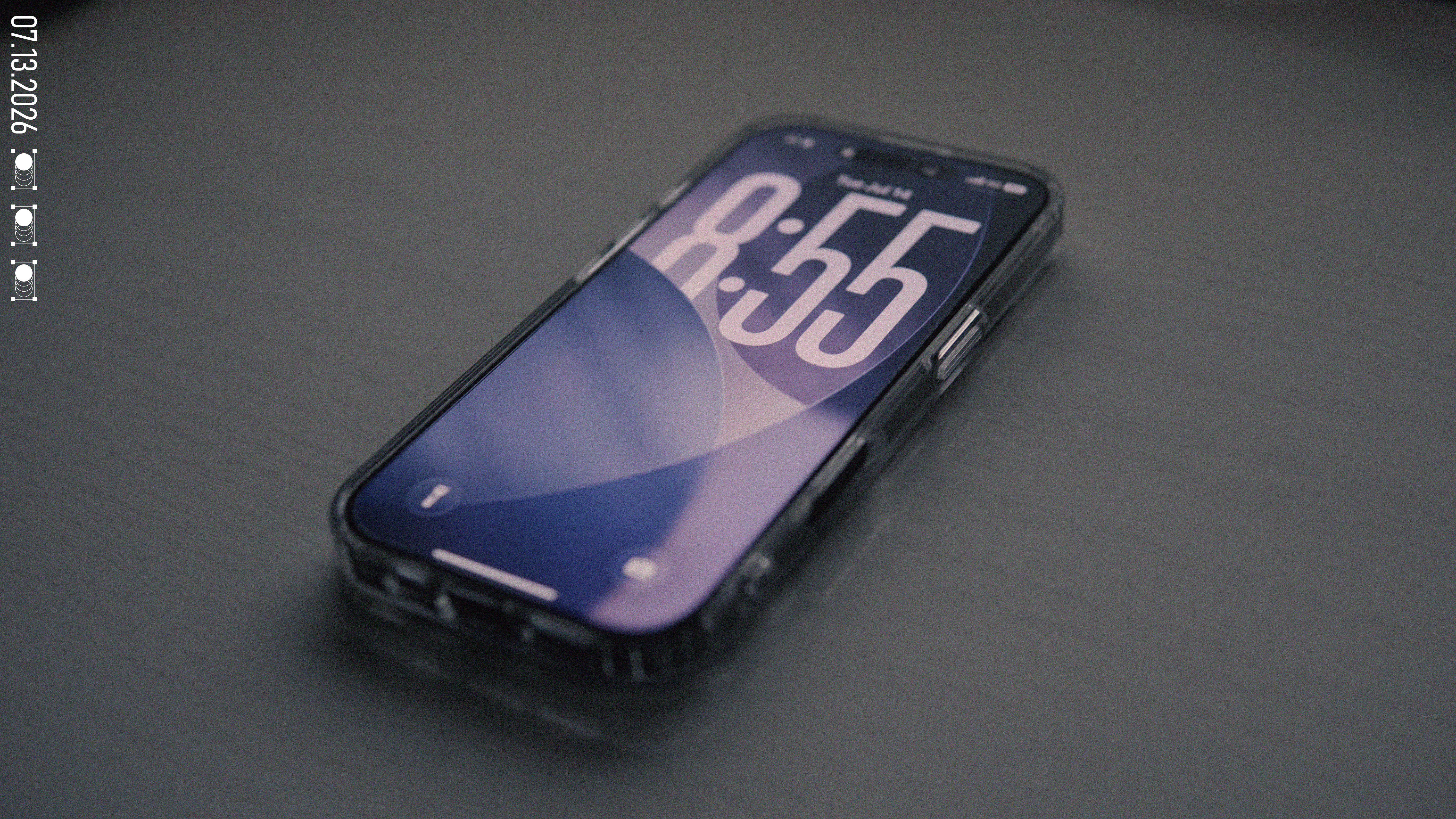 The iPhone 17 resting at an angle on a dark desk
